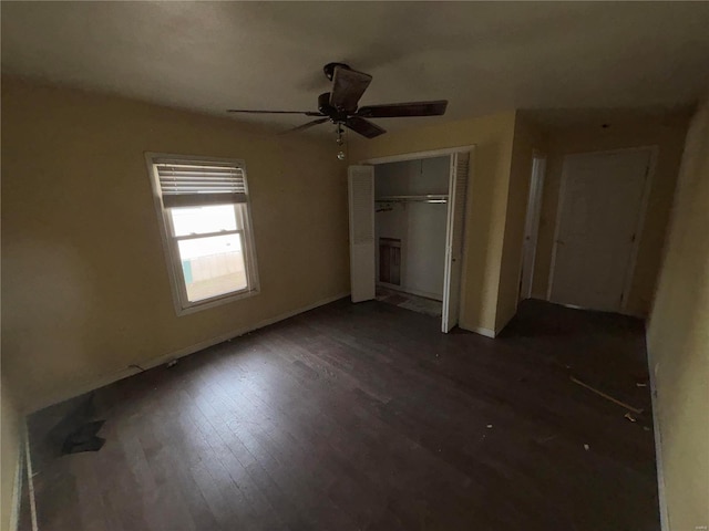 unfurnished bedroom with a closet, wood finished floors, and a ceiling fan