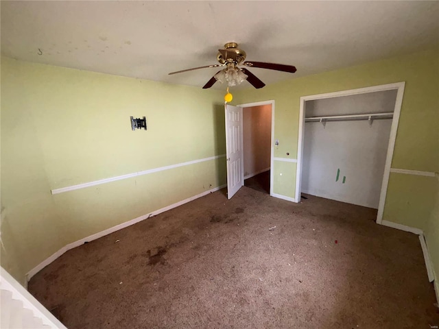 unfurnished bedroom with carpet floors, a closet, a ceiling fan, and baseboards