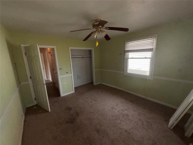 unfurnished bedroom with a closet, carpet flooring, ceiling fan, and baseboards