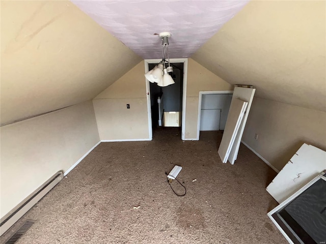 additional living space with a baseboard heating unit, carpet flooring, lofted ceiling, and baseboards