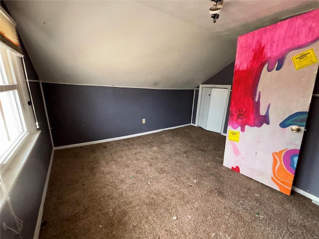 additional living space featuring lofted ceiling, carpet, and baseboards