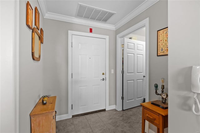 entrance foyer featuring baseboards, visible vents, crown molding, and tile patterned floors