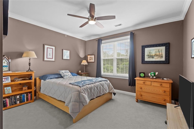 bedroom with baseboards, visible vents, crown molding, and carpet flooring