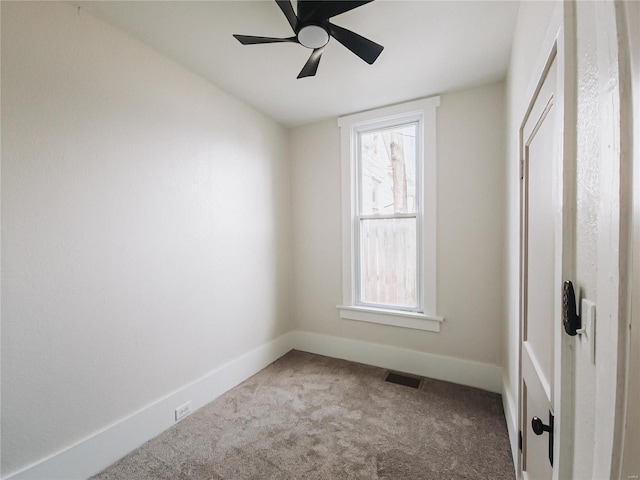 unfurnished bedroom featuring carpet floors, visible vents, baseboards, and ceiling fan