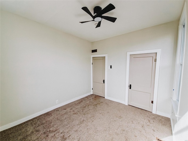 unfurnished bedroom with carpet, baseboards, and a ceiling fan