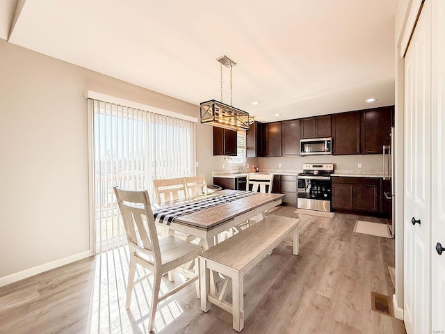 dining room with recessed lighting, baseboards, visible vents, and light wood finished floors