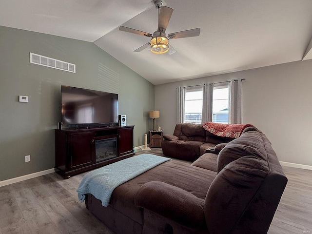 bedroom with baseboards, visible vents, lofted ceiling, ceiling fan, and light wood-type flooring