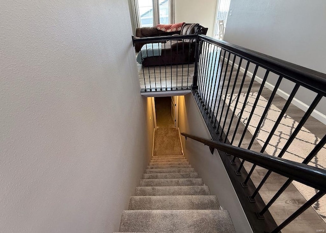 staircase featuring baseboards