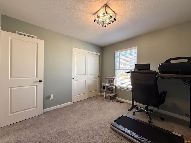 office space with visible vents, carpet flooring, a textured ceiling, a chandelier, and baseboards