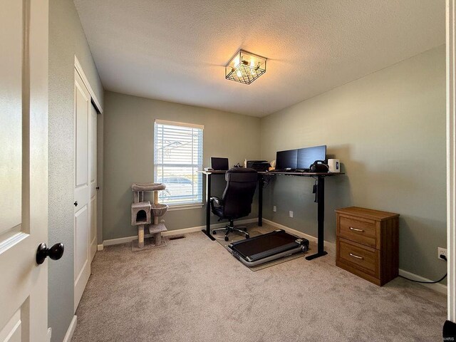 office space with carpet flooring, a textured ceiling, and baseboards