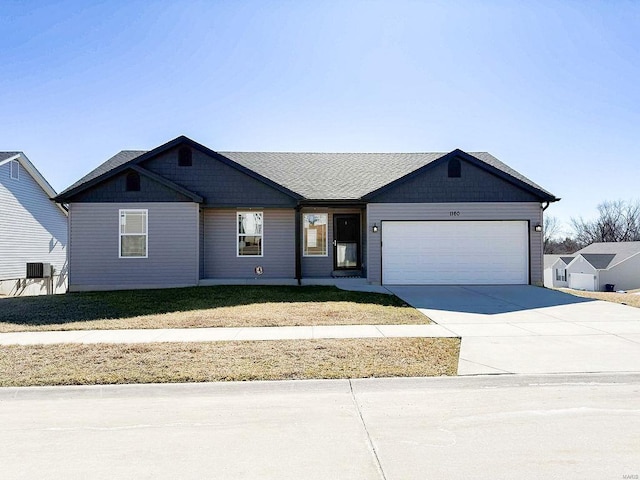 view of front of home with cooling unit, driveway, and an attached garage