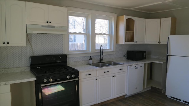 kitchen with under cabinet range hood, a sink, white cabinetry, black appliances, and tasteful backsplash