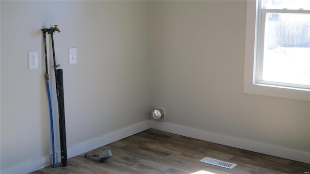 laundry area featuring laundry area, baseboards, visible vents, wood finished floors, and hookup for a washing machine