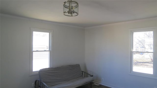 sitting room featuring ornamental molding, plenty of natural light, and baseboards