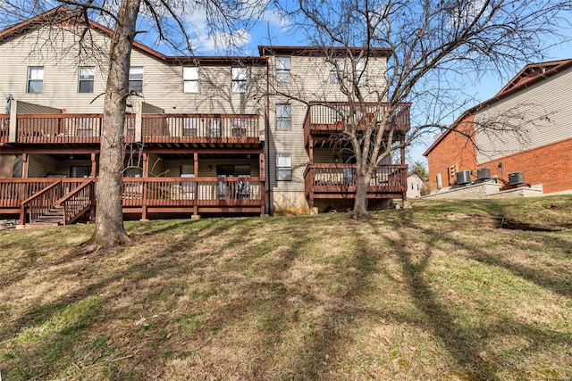 rear view of property with a yard, a deck, and central air condition unit