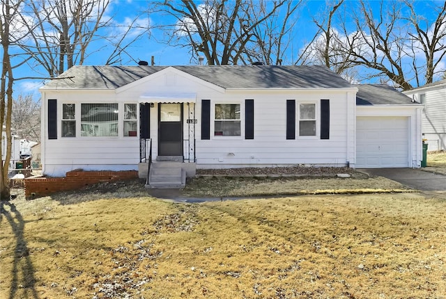 view of front of property with a garage, a front yard, driveway, and a shingled roof