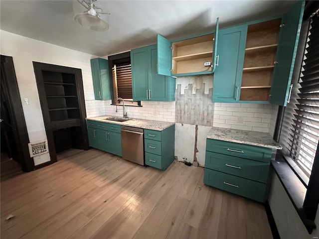 kitchen featuring a sink, green cabinets, stainless steel dishwasher, light wood-type flooring, and open shelves