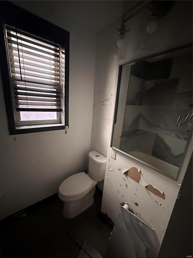 full bathroom featuring walk in shower and toilet