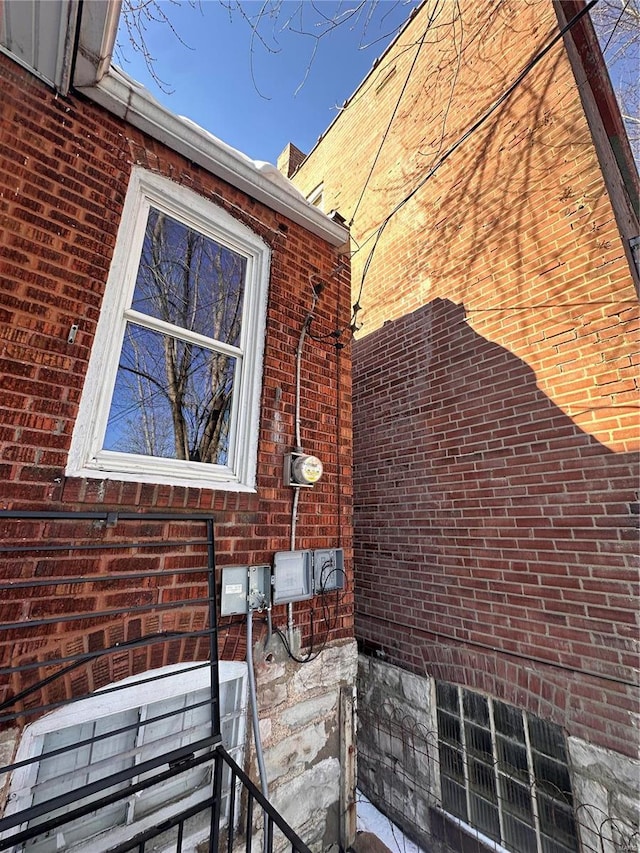 view of side of home with brick siding