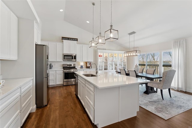 kitchen featuring a sink, dark wood-style floors, appliances with stainless steel finishes, white cabinets, and light countertops