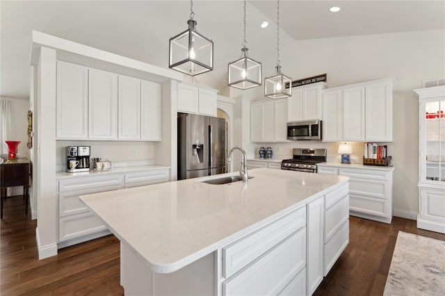 kitchen featuring a sink, stainless steel appliances, white cabinets, and dark wood-style flooring