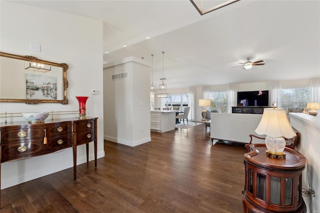 living area featuring a ceiling fan, wood finished floors, visible vents, baseboards, and recessed lighting