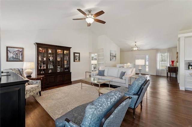 living room with baseboards, lofted ceiling, dark wood-style floors, and a ceiling fan