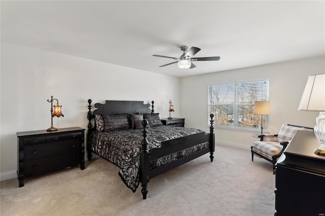 bedroom featuring light carpet, a ceiling fan, and baseboards