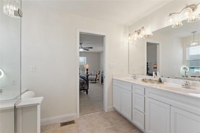 ensuite bathroom featuring double vanity, visible vents, ensuite bathroom, and a sink