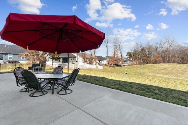 view of patio featuring outdoor dining area and fence