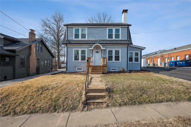 bungalow featuring a shingled roof, crawl space, stucco siding, a chimney, and a front yard