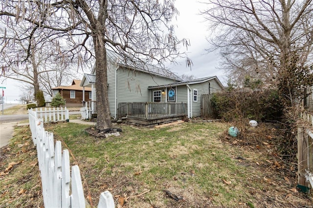 exterior space featuring a yard, fence, and a deck