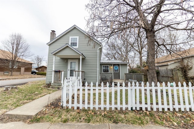 view of front of property featuring a fenced front yard and a chimney