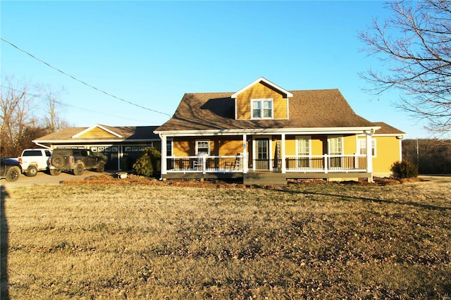 back of house with a garage and covered porch