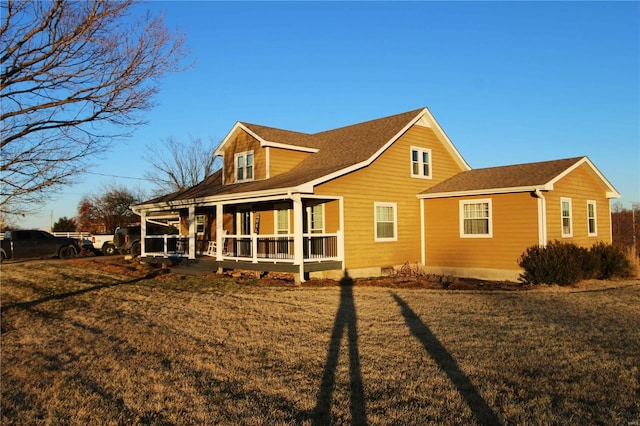 rear view of house featuring a lawn