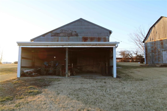 exterior space with a pole building, a lawn, and an outdoor structure