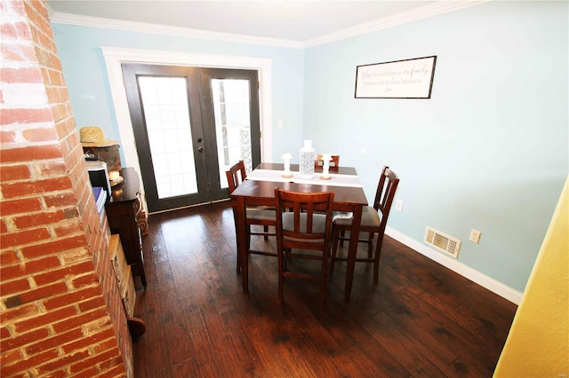 dining space with dark wood-style floors, french doors, visible vents, and crown molding