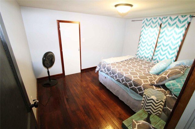 bedroom featuring wood-type flooring and baseboards