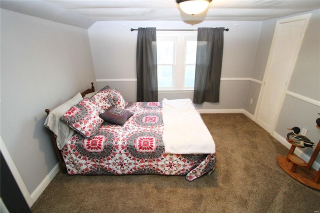 bedroom featuring baseboards, vaulted ceiling, and carpet flooring