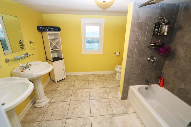 full bathroom with bathtub / shower combination, toilet, a sink, baseboards, and tile patterned floors