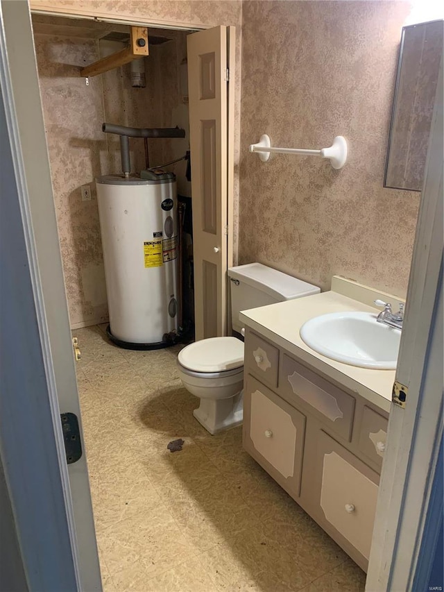 bathroom with wallpapered walls, toilet, water heater, tile patterned floors, and vanity