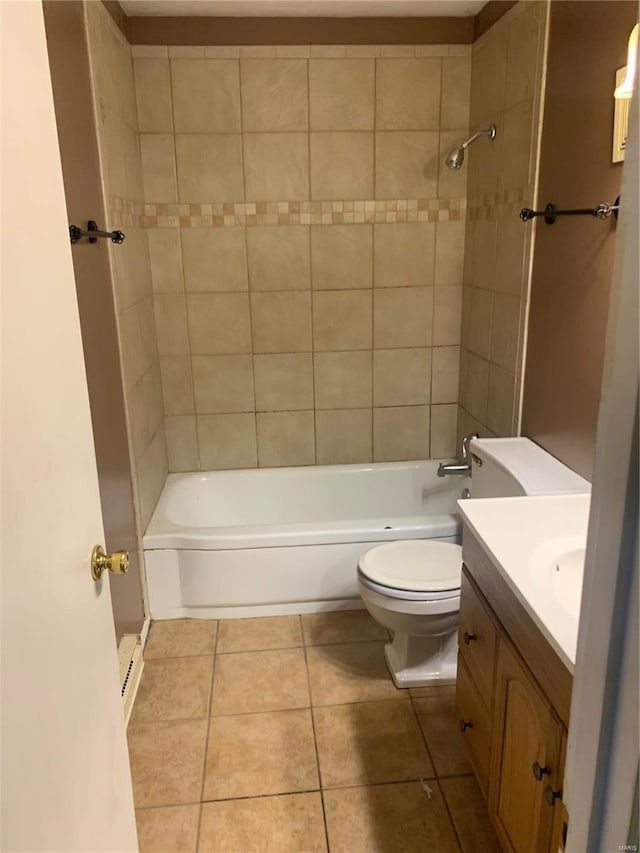 full bath featuring tile patterned floors, toilet, vanity, and washtub / shower combination