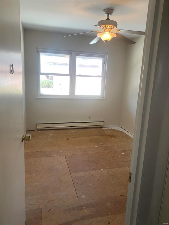 unfurnished room featuring baseboard heating and ceiling fan