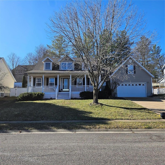 view of front of property featuring a garage, driveway, a front lawn, and a porch