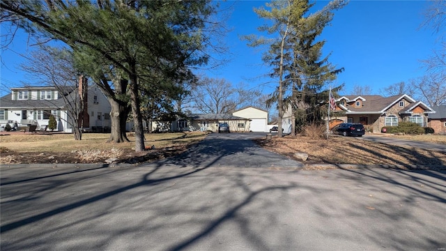 exterior space featuring aphalt driveway and a residential view