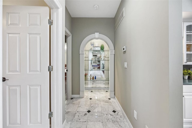 interior space featuring marble finish floor and baseboards