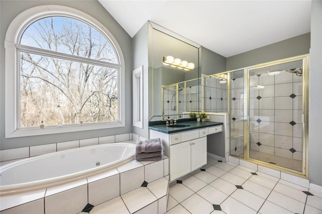 bathroom with a jetted tub, vaulted ceiling, a shower stall, and vanity