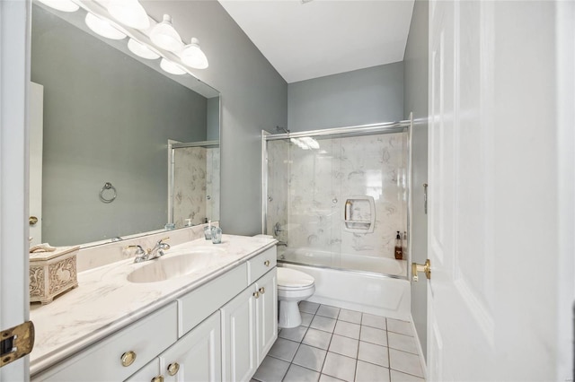 full bath with combined bath / shower with glass door, vanity, toilet, and tile patterned floors