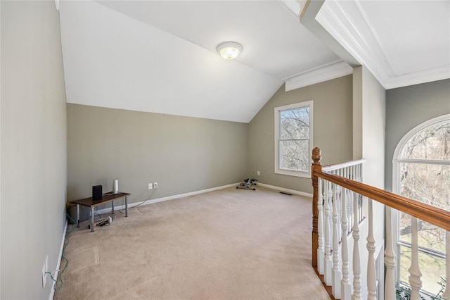 bonus room with a wealth of natural light, light colored carpet, vaulted ceiling, and baseboards