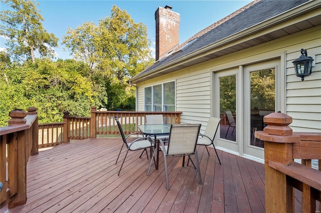 wooden terrace featuring outdoor dining area